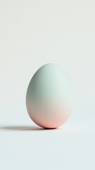 Fototapeta premium A white egg with a pink and green shell. The egg is sitting on a white surface. The egg is not cracked