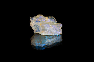 Natural rough blue sheen Moonstone gemstone with adularescence effect on dark background (selective focus)