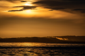 Sunrise over sea and distant land