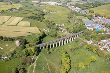 Aerial drone photo of the town of Thornton which is a village within the metropolitan borough City of Bradford in West Yorkshire, England showing the village and famous viaduct in the summer time.