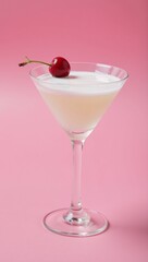 White cocktail with cherry on pink party backdrop party theme copy space