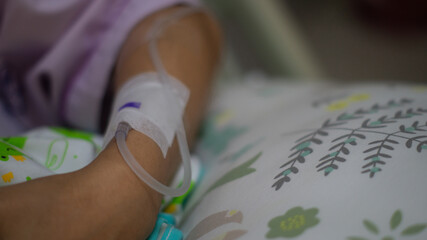 Close up An IV line in the arm of a patient had just given birth and was recuperating in the hospital.
