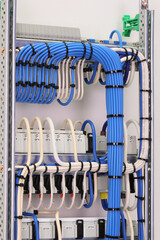 The reverse side of the electrical switchboard. The connected wires are tied with plastic ties.