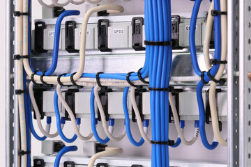 The reverse side of the electrical switchboard. The connected wires are tied with plastic ties.