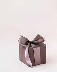 Obraz premium A square gift box with a ribbon, against a white background, in shades of dark purple and brown. Christmas, Valentine and birthday banner