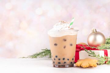 Christmas cafes menu background, iced festive Gingerbread boba tea bubble balls Oat Milk Chai tea or Latte with non-dairy whipped creamer, Gingerbread syrup, tapioca balls, cookies crumbs, spices