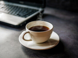 Relax during business work concept, americano coffee cup and black coffee cup aromatic and laptop computer in morning