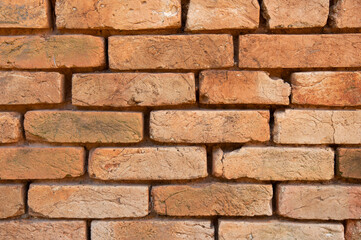 Old orange clay bricks wall background. Bricks backdrop