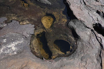 A pit formed by erosion from water over a long period of time.