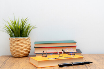 book eyeglass and pen on the table