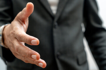 Businessman with an open hand ready for handshake