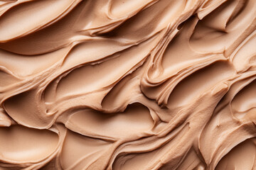 Obraz premium A creamy mocha mousse background with soft swirls of chocolate and coffee tones, creating a smooth texture.