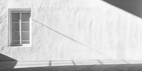 Minimalist white wall with textured brush strokes and natural light shadows.