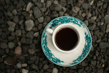 vintage ceramic cup with arabica coffee filter filling