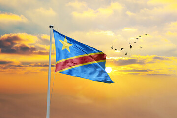 Waving flag of DR Congo against sunset or sunrise. DR Congo flag for Republic Day and Independence Day.