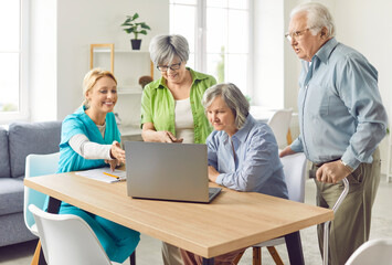 Fototapeta premium Senior group and caring kind nurse, geriatric medicine caretaker helping with laptop for nursing home residents, senior adult in assisted living, female doctor visiting patient, caregiving service