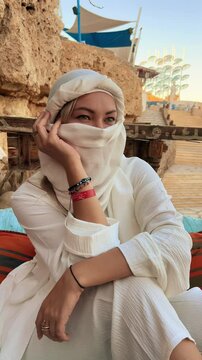 A beautiful girl in traditional clothes rests in a cafe in Egypt