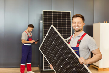 Portrait of a happy technician holding a solar panel in a store. His expertise in photovoltaic...