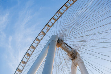 Part of Ferris wheel against the backdrop of a blue sky and the Persian Gulf. Dubai