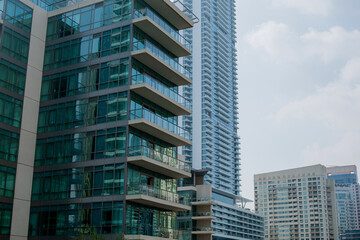 Obraz premium High-rise buildings with glass facade against blue sky. Business center. View from below