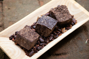 Organic chocolate from the Oaxaca region of Mexico produced in a traditional way on a metate, an ancient stone tool for grinding products.