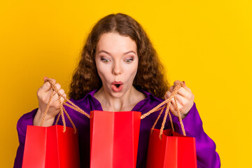 Photo portrait of attractive young woman hold shopping bags peek amazed dressed stylish violet...