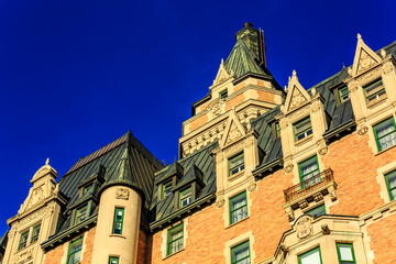 A large brick building with a green roof and a clock tower