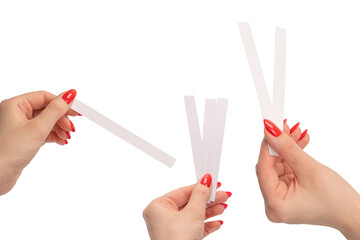 Woman hand with red nails with test strips for the perfume, isolated on a white background.