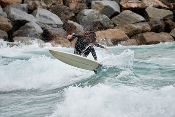 Surfboarder with long hair riding a wave