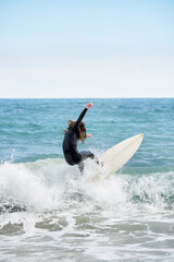 Surfboarder with long hair riding a wave