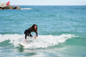 Surfboarder with long hair riding a wave