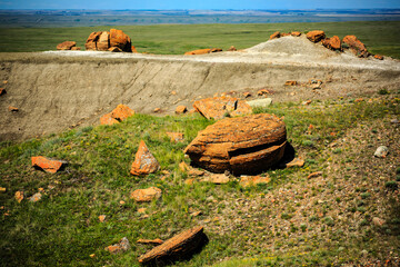 A rocky hillside with a large rock in the middle