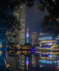 Colombo Lotus tower with lights in the city at night with water reflection 