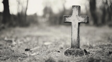Old Weathered Cross in a Cemetery Surrounded by Nature in Black and White