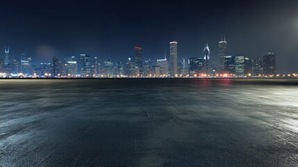 Nighttime city skyline with a reflective surface in the foreground.