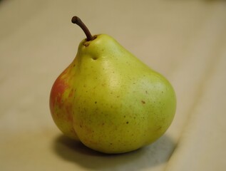 A Single Ripe Pear on a Beige Background