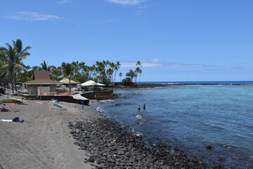The black sand lava and magma beaches with the turquoise pacific ocean in the back on the big...