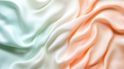Fototapeta premium Soft pastel fabric folds in peach and mint hues, creating a gentle, flowing texture.
