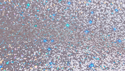 Glittering silver and blue sparkle background creating festive atmosphere