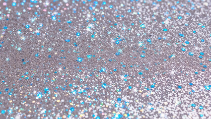 Glittering silver and blue sparkle background creating festive atmosphere