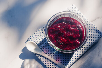 homemade mix berry jam in a glass bowl on white table background.