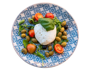 Buffalo mozzarella, olives, tomatoes and basil on a plate with a blue pattern