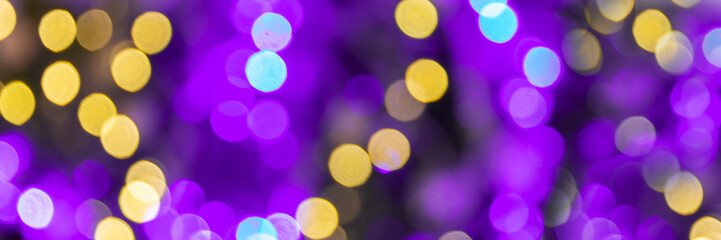 Purple and gold bokeh holidays lights at night, christmas, new year or Mardi Gras carnival party...