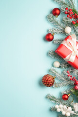 Christmas present with decor on blue background with space for design.