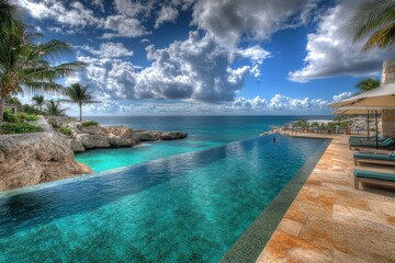 A stunning infinity pool overlooking a serene ocean and dramatic sky.