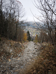 Rocky mountain path leading to chamonix village in autumn November