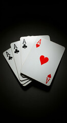 Obraz premium Four Aces fanned out on a dark background.