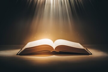 an open book placed on a flat surface, with a radiant beam of light shining down on it