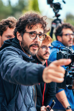 Film director pointing while giving instructions to actors, intense focus on facial expressions