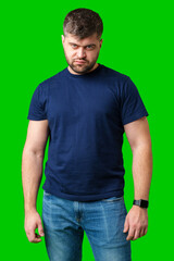 Man expressing confusion with crossed arms in front of a bright green background